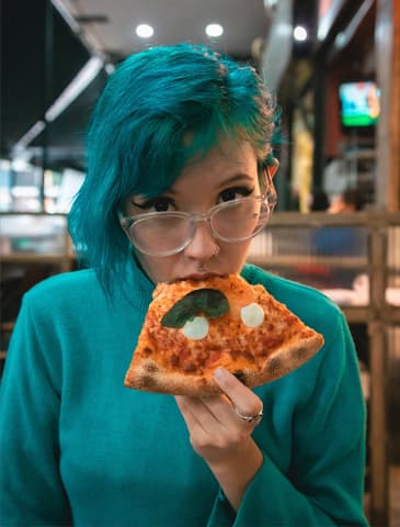 woman eating pizza